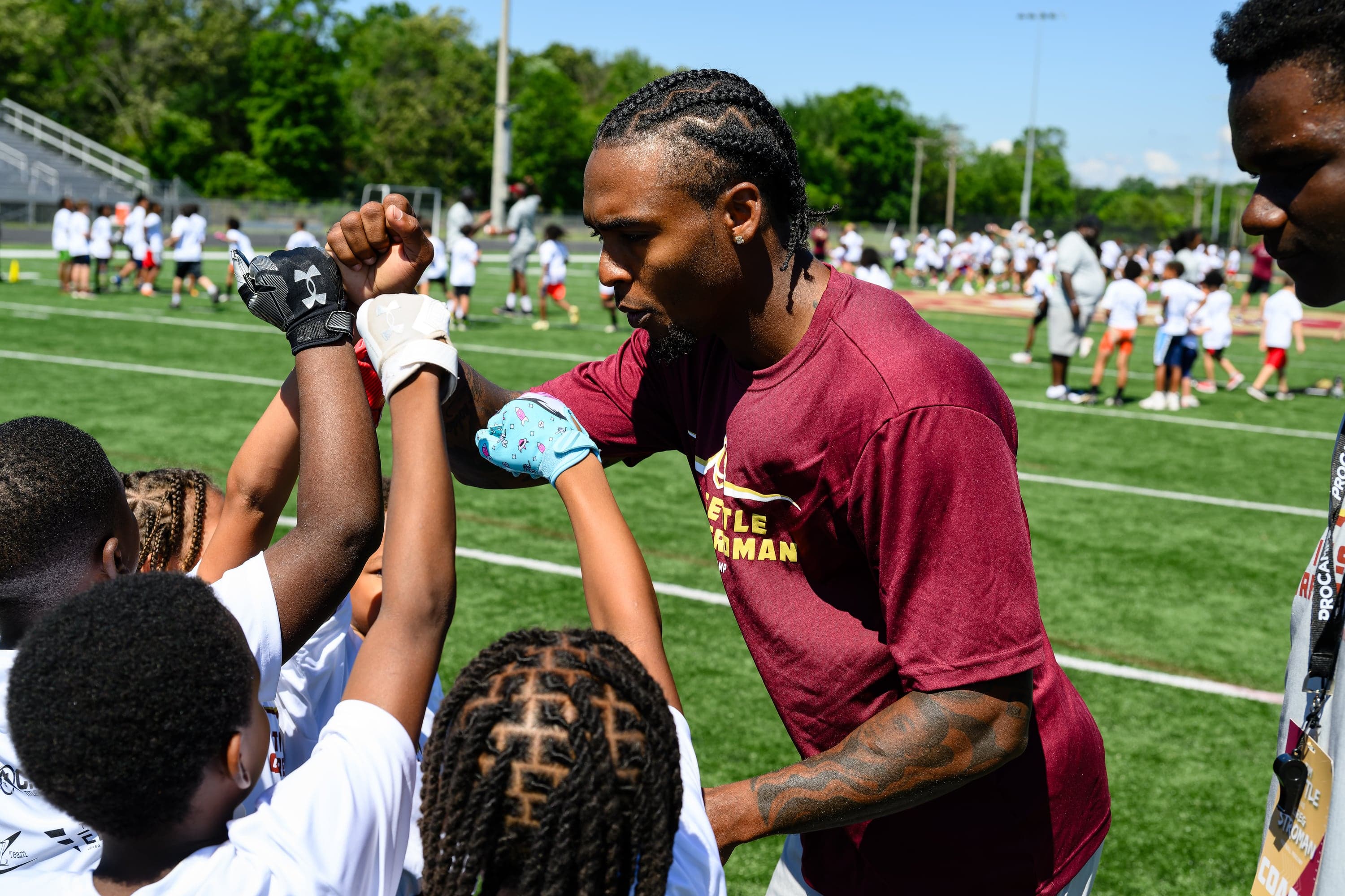 Football athletes breaking from a huddle